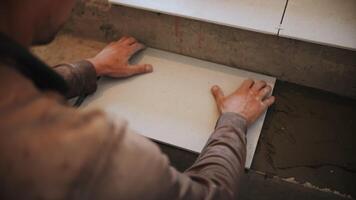 Master laying ceramic tiles on stairs video