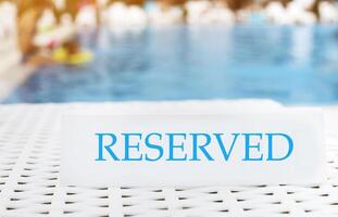 Reserved sign on the summer pool background photo