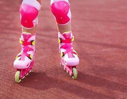 Rollerblades inline skates of a child closeup in action outdoors photo