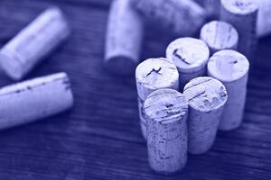 Dated wine bottle corks on the wooden background photo