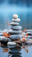 close up of Balanced rocks on a blue vertical background on a foreground of water. concept temporary sculpture made of stones as an example of art or the result of meditation photo