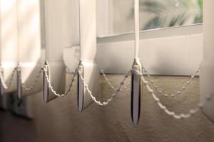 Modern vertical fabric blinds on the window in the office photo