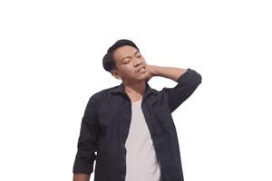 A man in a black shirt holds his neck with a pained expression, indicating discomfort or neck pain. The plain white background emphasizes his distress and highlights photo