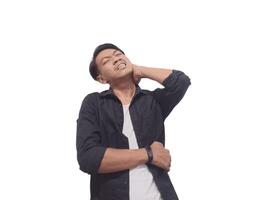 A man in a black shirt holds his neck with a pained expression, indicating discomfort or neck pain. The plain white background emphasizes his distress and highlights photo