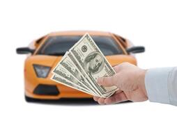 Hand holding money and a car on white background photo