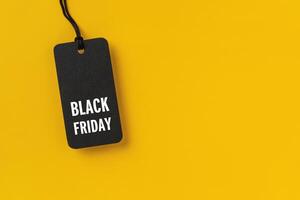 Sale tag with Black Friday written on yellow background photo