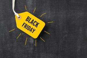 Sale tag with Black Friday written on blackboard photo