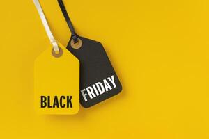 Sale tags with Black Friday written on yellow background photo