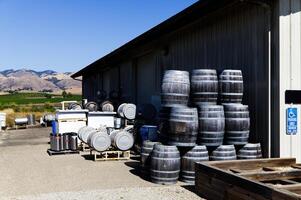San Luis Obispo, CA, 2024 - Wooden Wine Casks Stacked Behind Winery Building photo