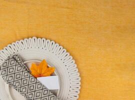 Elegant table setting for a cozy autumn gathering, copy space photo