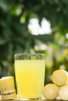 Drink from sugar cane juice, squeezed sugar cane juice with sugar cane stalks and natural background photo