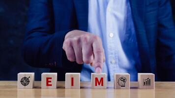 EIM Enterprise information management system on wooden cubes, EIM Global Network with Analyzing Technological Data, Efficient Information Management. photo