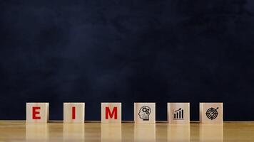 EIM Enterprise information management system on wooden cubes, EIM Global Network with Analyzing Technological Data, Efficient Information Management. photo
