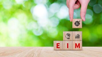EIM Enterprise information management system on wooden cubes, EIM Global Network with Analyzing Technological Data, Efficient Information Management. photo