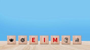 EIM Enterprise information management system on wooden cubes, EIM Global Network with Analyzing Technological Data, Efficient Information Management. photo