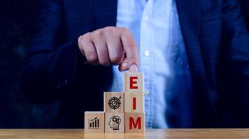 EIM Enterprise information management system on wooden cubes, EIM Global Network with Analyzing Technological Data, Efficient Information Management. photo