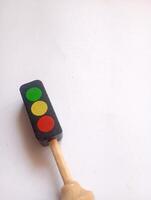 A photo of a wooden block shaped like a traffic light, styled in isolation with space for text.