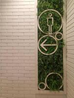 A photo of directional signs for men's restroom