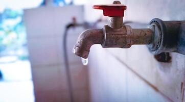 Old Faucet with Water Dripping photo