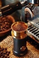 A coffee grinder is shown with a large amount of coffee beans in it photo