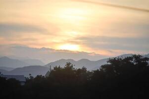 sky ,tree , mountain and house background or a house and tree photo