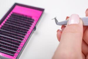 Eyelash Extension tools on white background. Accessories for eyelash extensions. Artificial lashes. photo