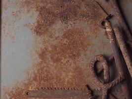 Rusted steel surface with old nails and equipment for a vintage background. photo