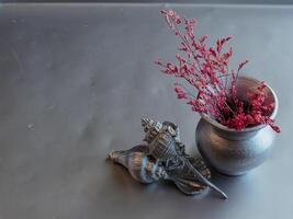 Dried flowers in vase with silver heart gift box, concept for birthday or Valentine's Day. photo