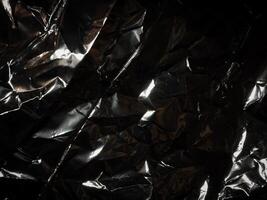 Silver foil in the dark for a mysterious abstract background. photo