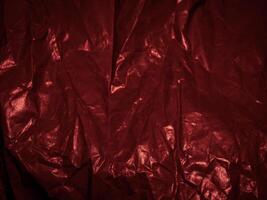 Wrinkled paper texture in dark red tones for a mysterious background. photo