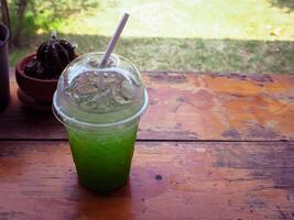 Kiwi soda drink in the garden cafe photo