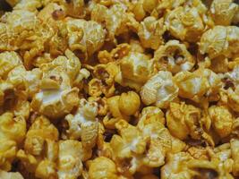 Delicious sweet popcorn, close-up shot for dessert food background. photo