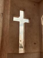 a cross is seen through a window in a building photo