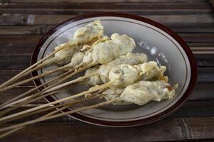 Sempolan or sempol is a type of fried food made from tapioca flour which is oval in shape and skewered, with a chewy texture, eaten with spicy red sauce and soy sauce or can be added with peanut sauce photo