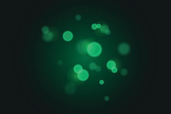 Beautiful green light effect on dark background, glare, beautiful diffused light, bokeh effect