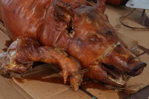 a pig that is cooked and on a table photo