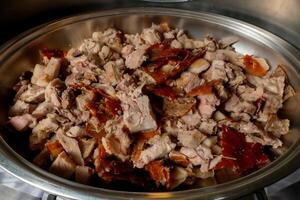 A bowl of meat and vegetables in a metal pan photo