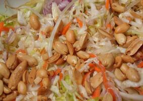 a plate of salad with nuts and carrots photo