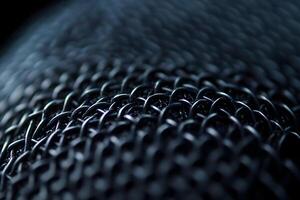 Detailed Close-Up of Microphone Mesh with Metal Texture on Plain Background photo
