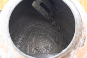 Mixing mortar in a handheld portable concrete mixer photo