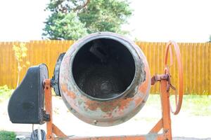 Mixing mortar in a handheld portable concrete mixer photo