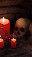 Abstract Halloween background composition with a skull and candles. Design. Cartoon creepy human skull and burning candles, concept of black magic and mysticism. video