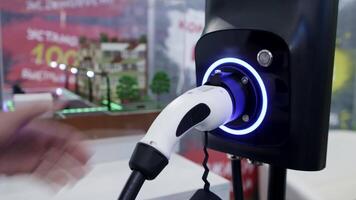 The modern Electric Vehicle Charging Station features a convenient glow indicator for easy use. Media video