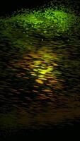 Organized movement of dynamic colorful particles in a form of a 3D sphere on black background. Animation. Technological background, green and yellow atoms flying in a circle. video