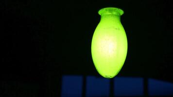 A Glowing Green Light Fixture Set Against a Dark Background, Creating an Eye Catching Contrast. Stock Clip video