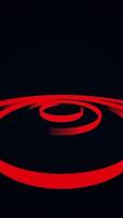 Abstract red 3d lines creating spherical object spinning on a black background. Media. Contrasting spinning lined shape. Vertical . video