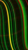 Abstract colorful wavy background in bright colors. Media. Glowing narrow bended strings. Vertical . video