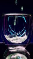 Bright art shooting . Stock Clip . An illuminated purple background that changes color and standing bright alcohol with lemon and fir branches . video