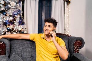 Portrait of young adult man using a phone while make a call phone. photo