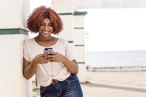 smile african american woman using a smartphone with copy space. communication concept. photo